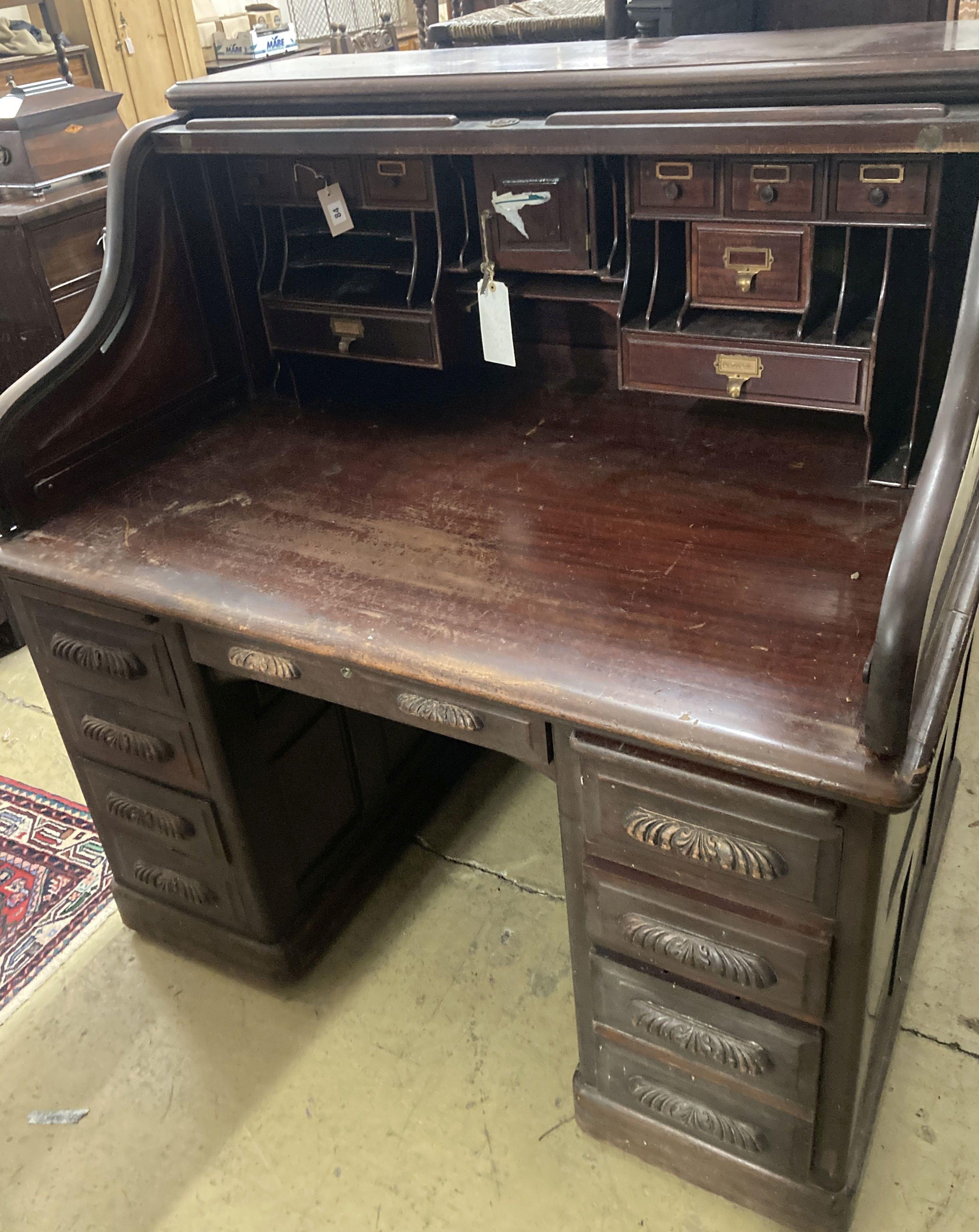 An Edwardian mahogany S roll top desk, width 128cm, depth 92cm, height 132cm